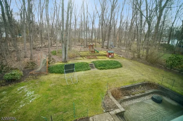 a view of backyard with swimming pool and green space