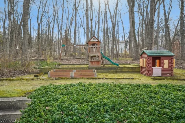 a view of a white house with a large pool lawn chairs and a yard
