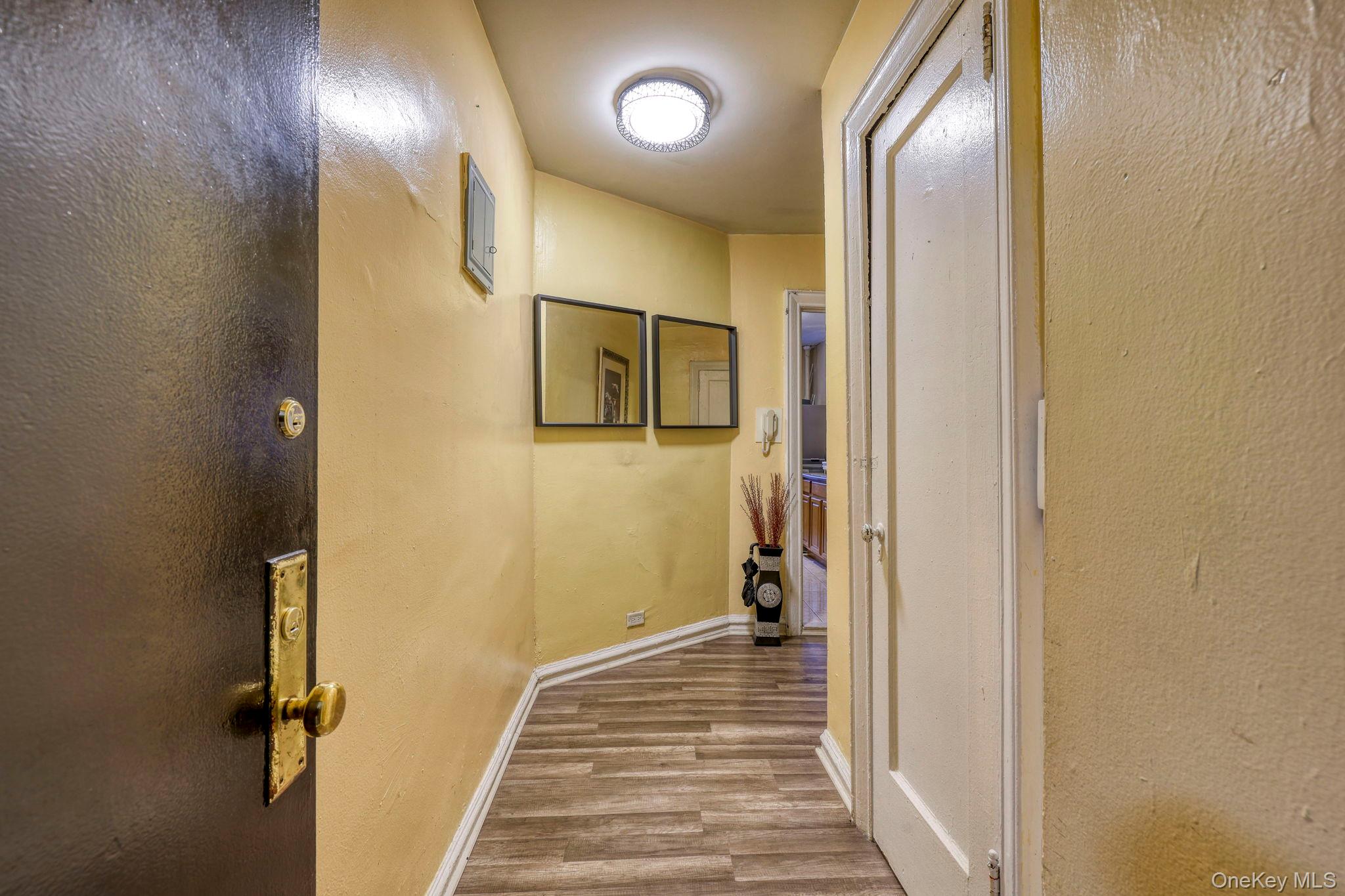 1372 Shakespeare Avenue, Unit 2H Bronx, NY 10452 - Photo 4 of 14 a view of a hallway with wooden floor