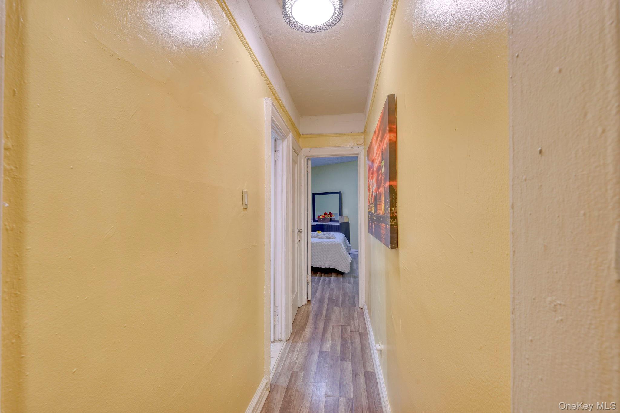 1372 Shakespeare Avenue, Unit 2H Bronx, NY 10452 - Photo 9 of 14 a view of a hallway with wooden floor