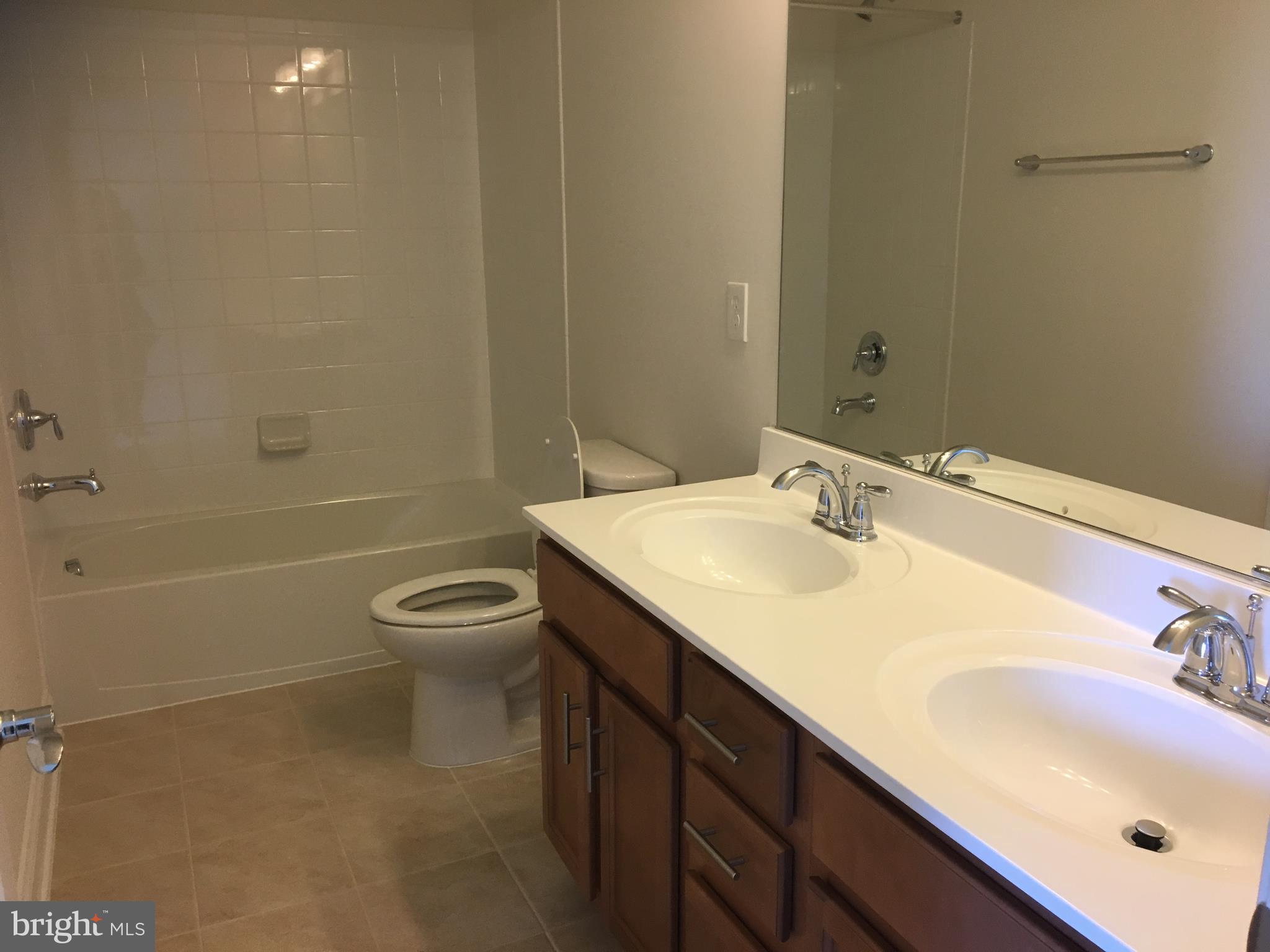 22591 Amendola Terrace Ashburn, VA 20148 - Photo 22 of 39 a bathroom with a sink toilet tub and shower