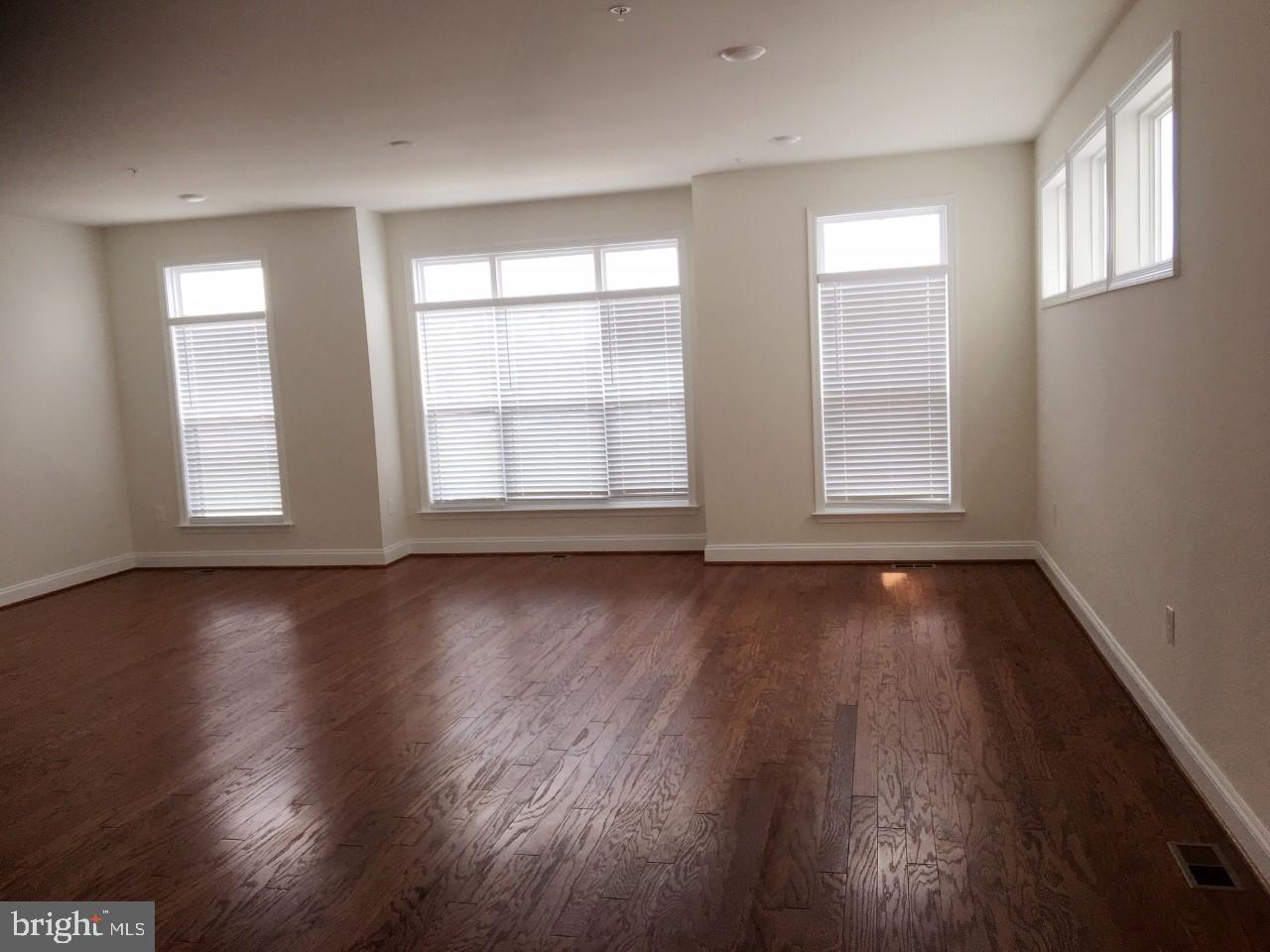 22591 Amendola Terrace Ashburn, VA 20148 - Photo 31 of 39 an empty room with wooden floor and windows