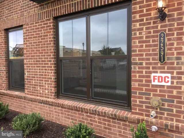 a view of a big room with wooden floor and windows