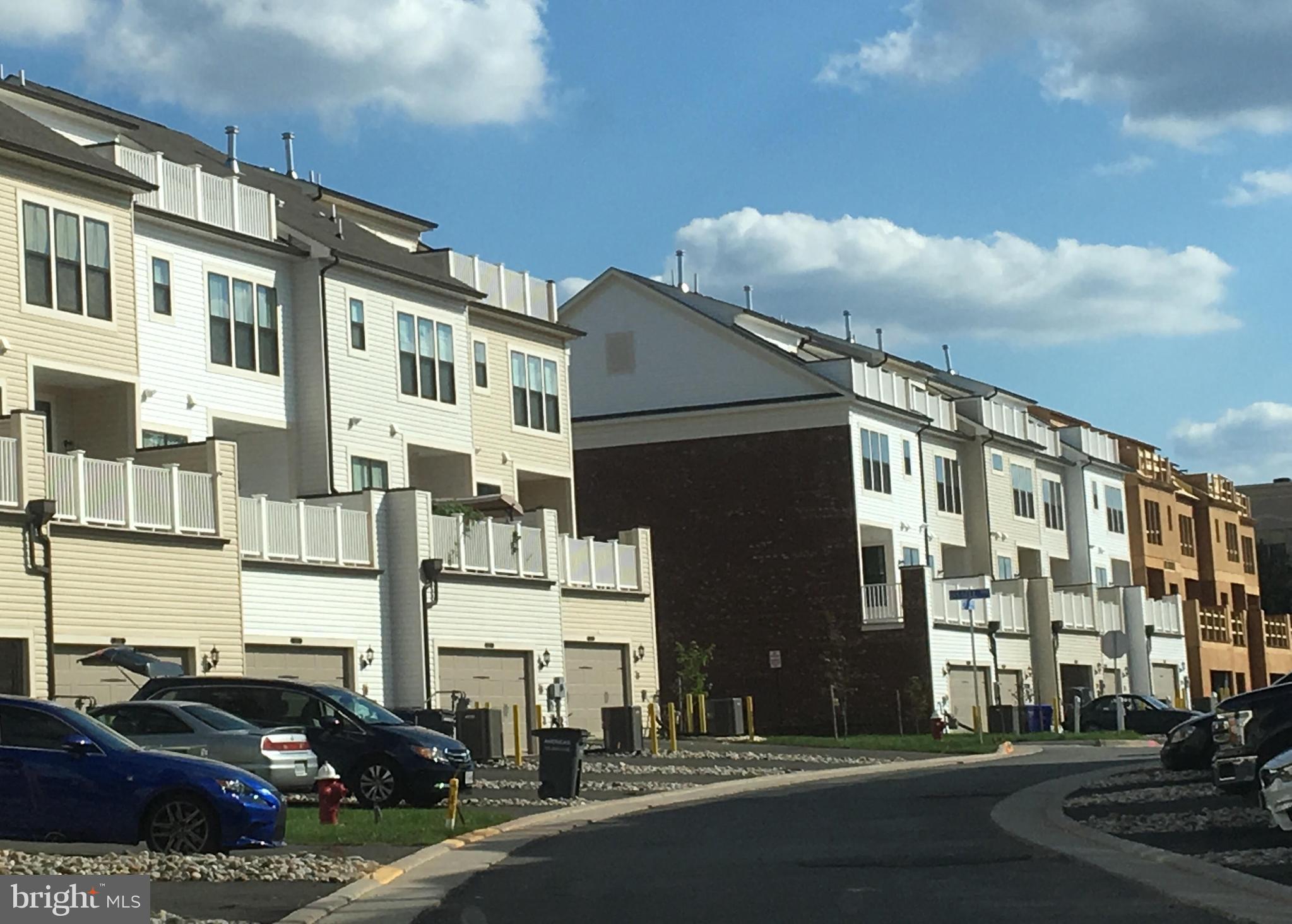 22591 Amendola Terrace Ashburn, VA 20148 - Photo 7 of 39 a city street lined with parked cars and buildings