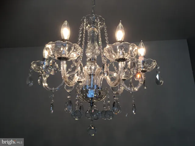 an empty room with wooden floor & windows