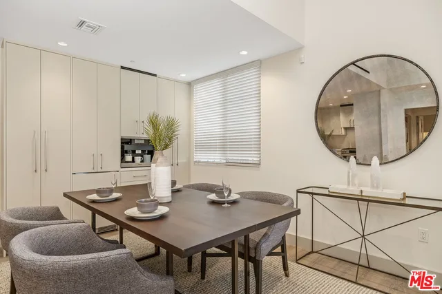 a view of a dining room with furniture and a potted plant