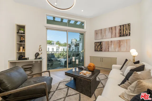 a living room with furniture a floor to ceiling window and a flat screen tv