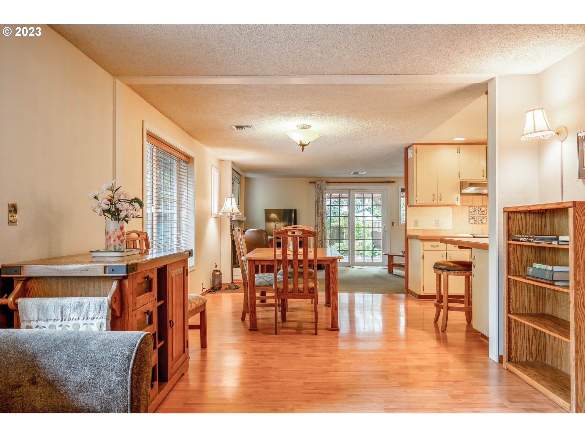 2565 Windsor Circle East Eugene, OR 97405 - Photo 11 of 38 a living room with furniture and a dining table with wooden floor