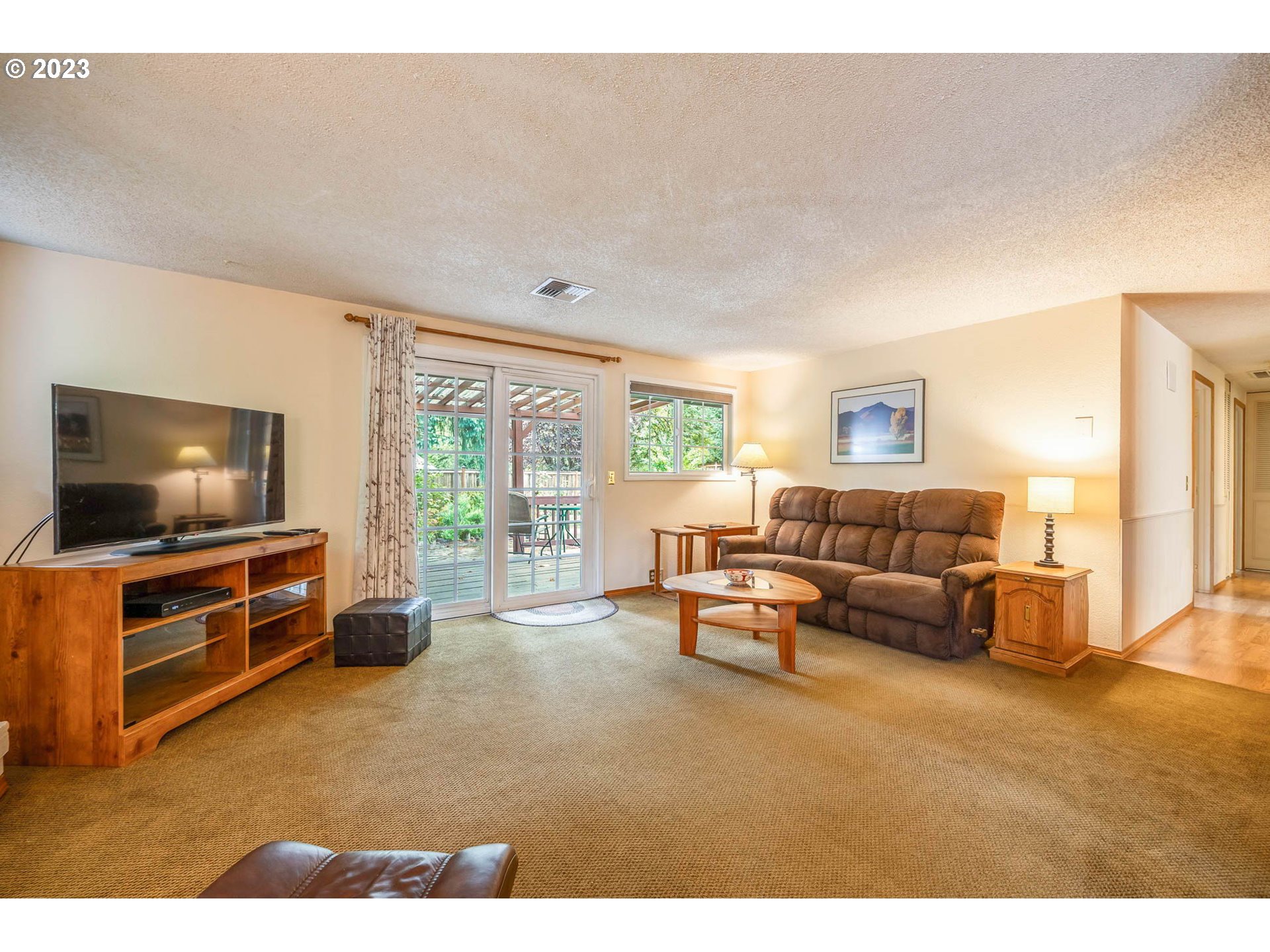 2565 Windsor Circle East Eugene, OR 97405 - Photo 15 of 38 a living room with furniture and a flat screen tv