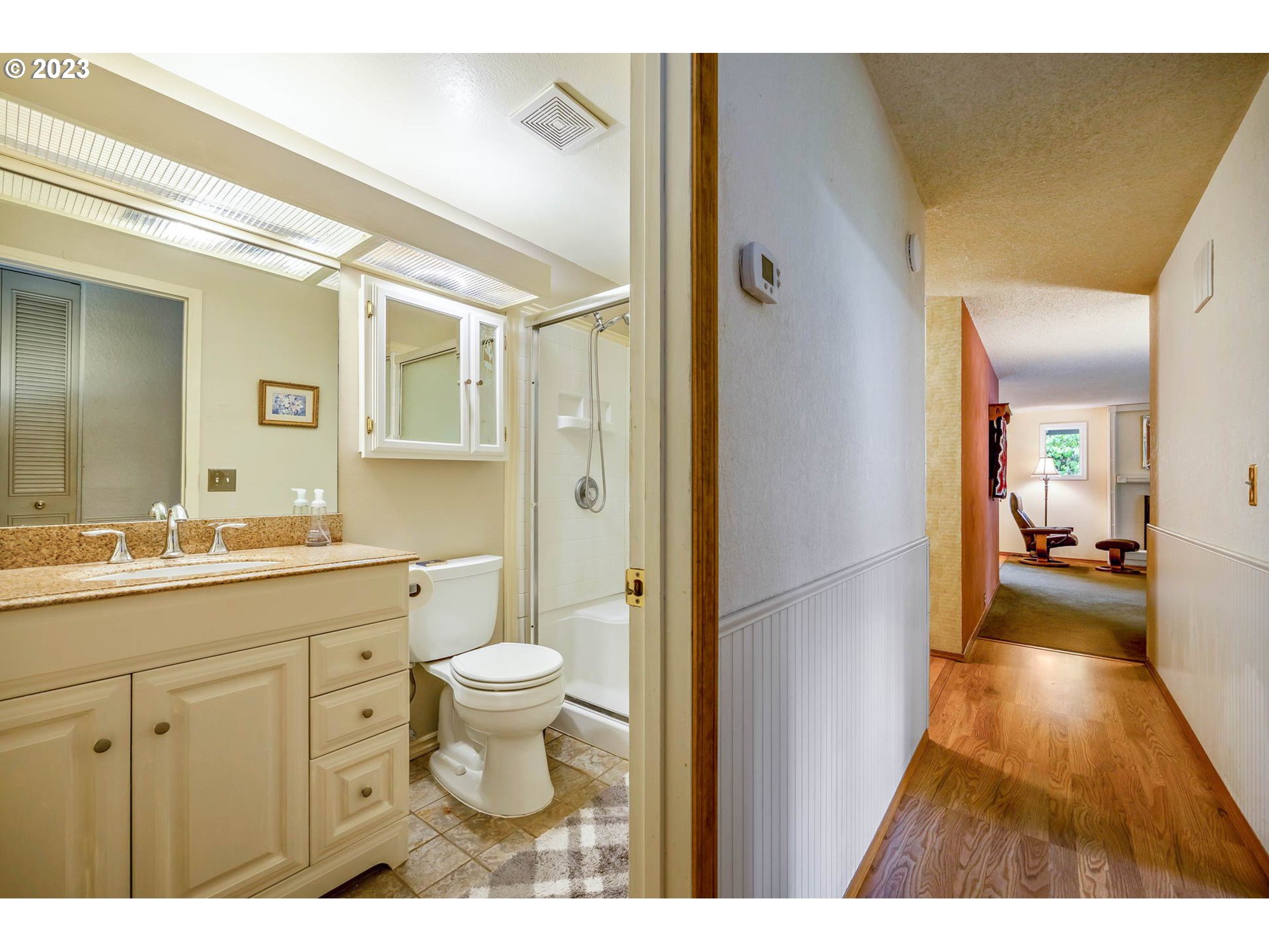 2565 Windsor Circle East Eugene, OR 97405 - Photo 20 of 38 a bathroom with a sink a toilet a shower and a mirror