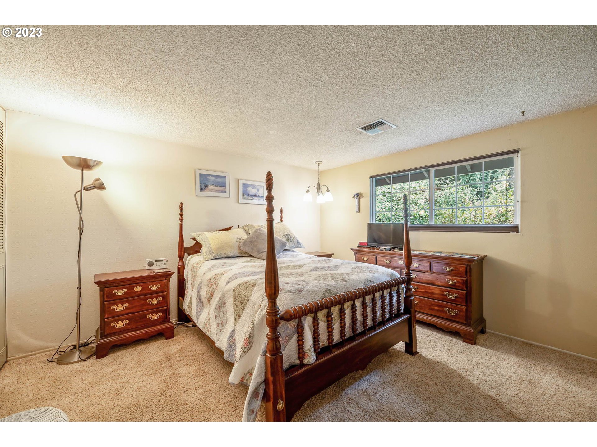 2565 Windsor Circle East Eugene, OR 97405 - Photo 21 of 38 a bedroom with a bed a dresser next to a window