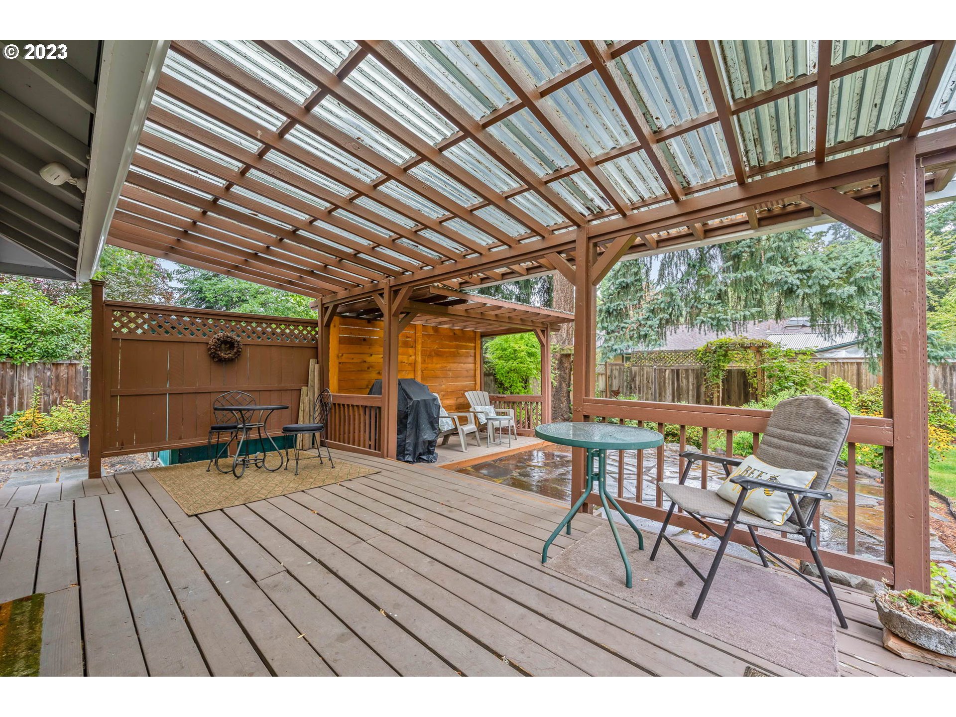 2565 Windsor Circle East Eugene, OR 97405 - Photo 26 of 38 a view of a patio with table and chairs and wooden floor with a barbeque