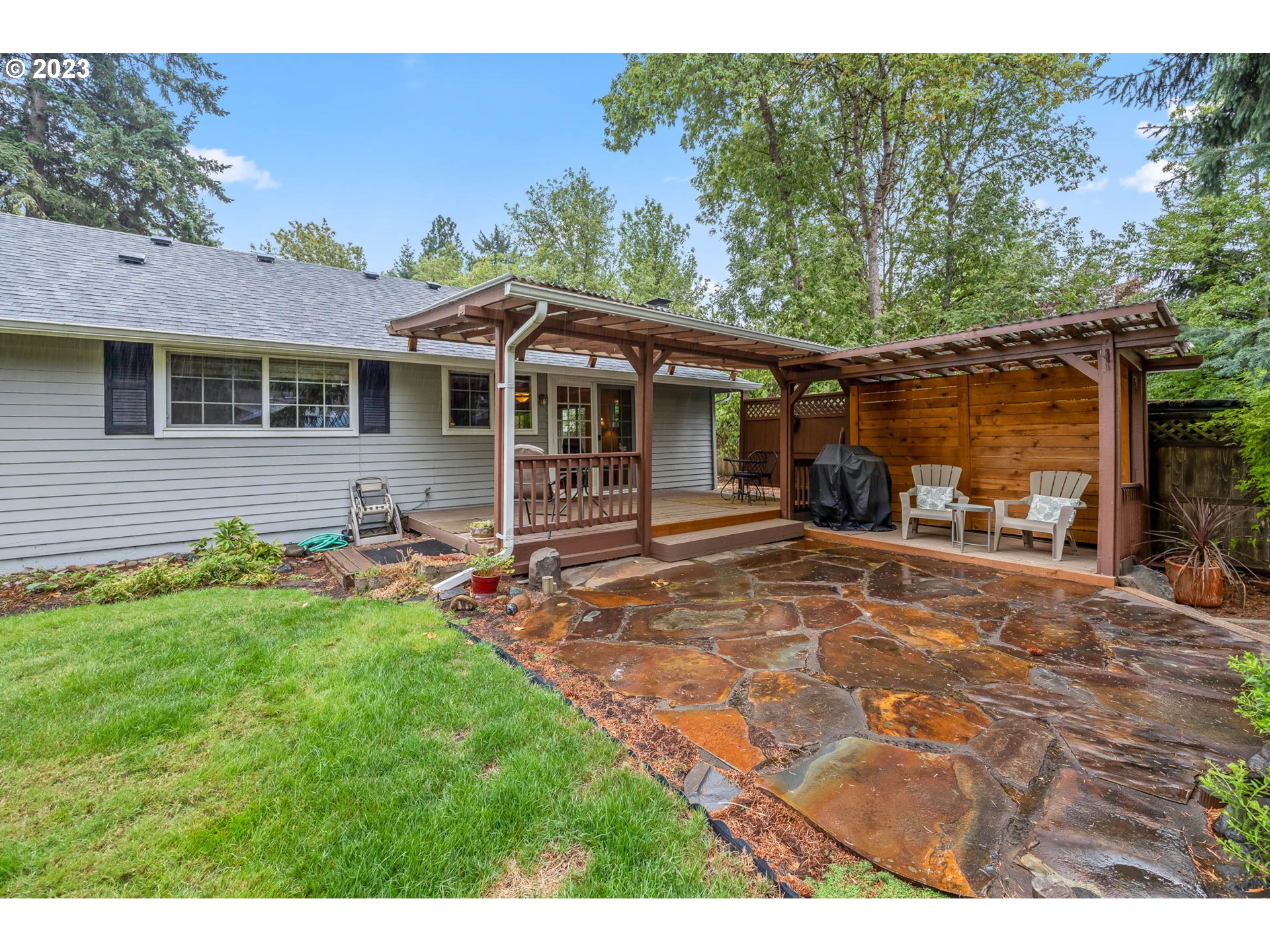 2565 Windsor Circle East Eugene, OR 97405 - Photo 29 of 38 a backyard of a house with yard table and chairs