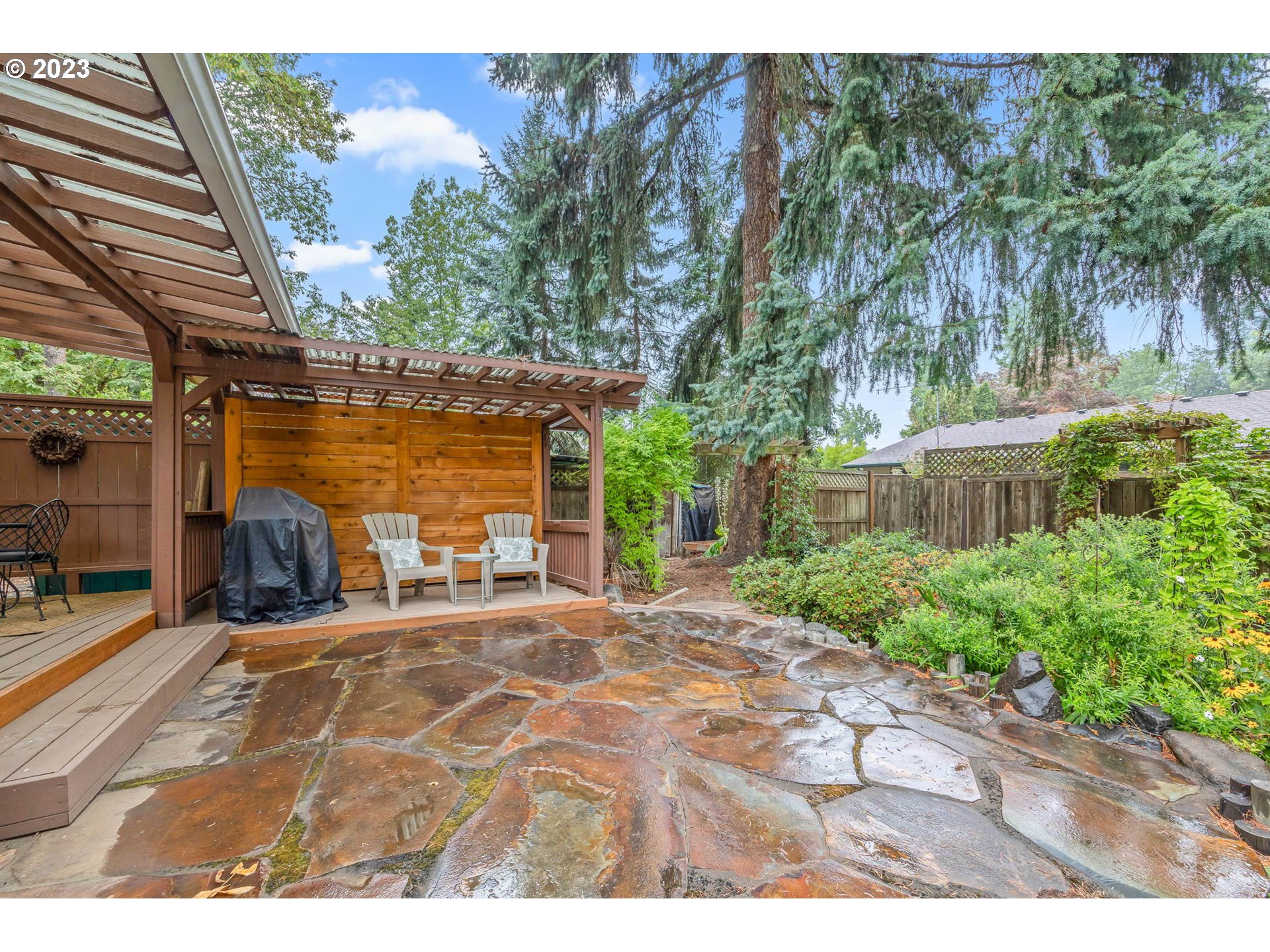 2565 Windsor Circle East Eugene, OR 97405 - Photo 30 of 38 a view of a backyard with table and chairs and potted plants