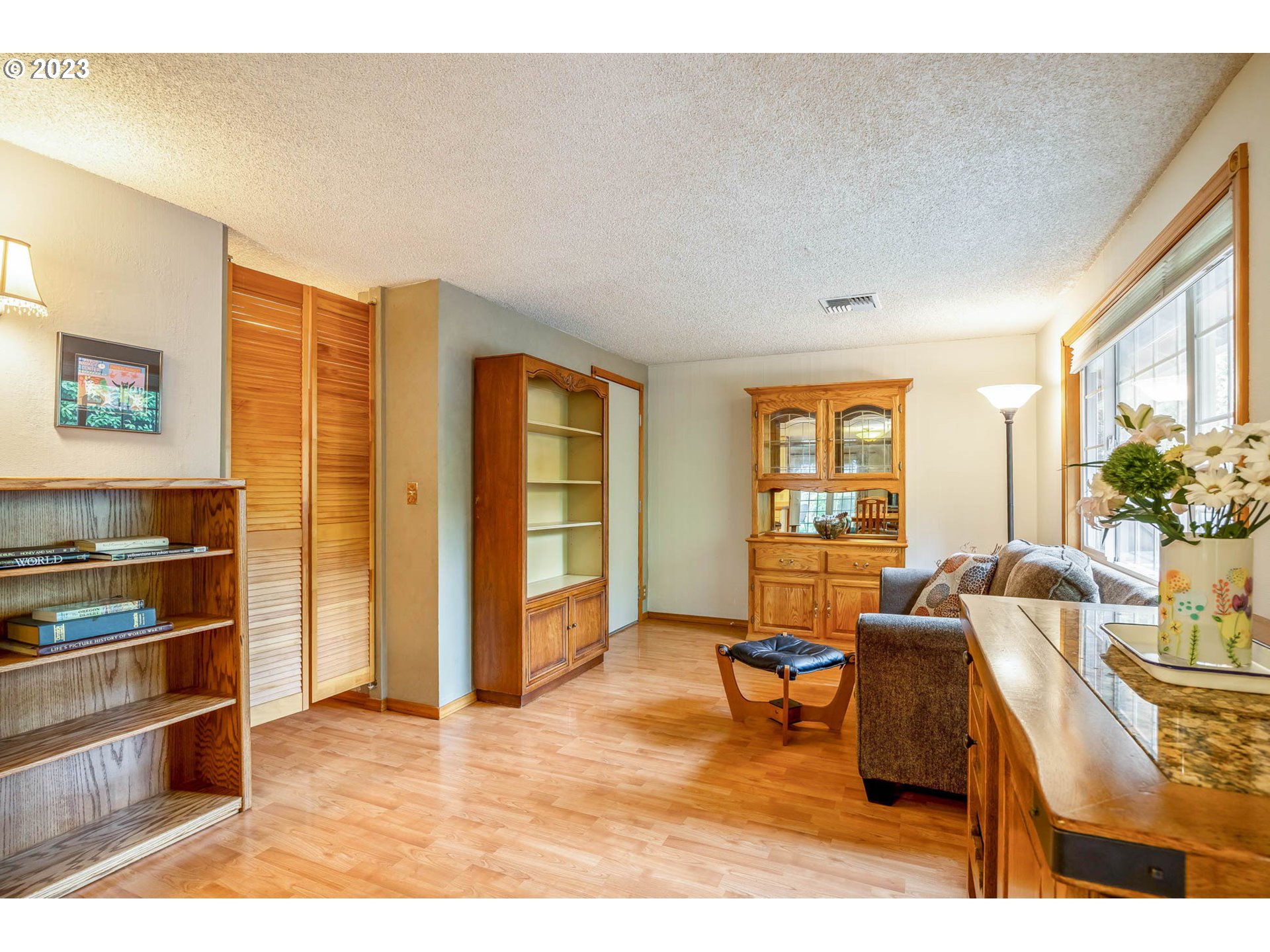 2565 Windsor Circle East Eugene, OR 97405 - Photo 10 of 38 a living room with furniture a window and kitchen view