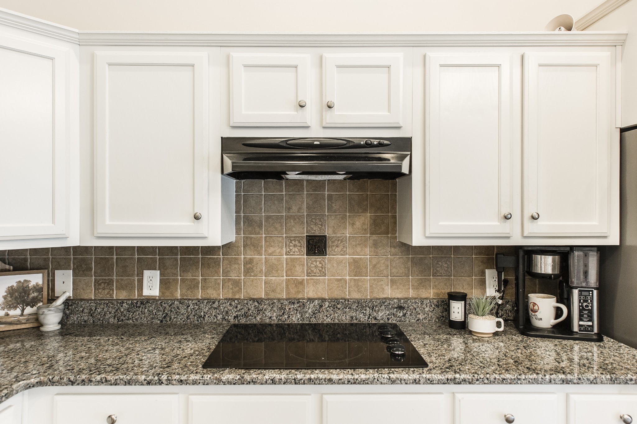 4305 Franklin Road Lebanon, TN 37090 - Photo 18 of 67 a kitchen with granite countertop a stove a sink and white cabinets