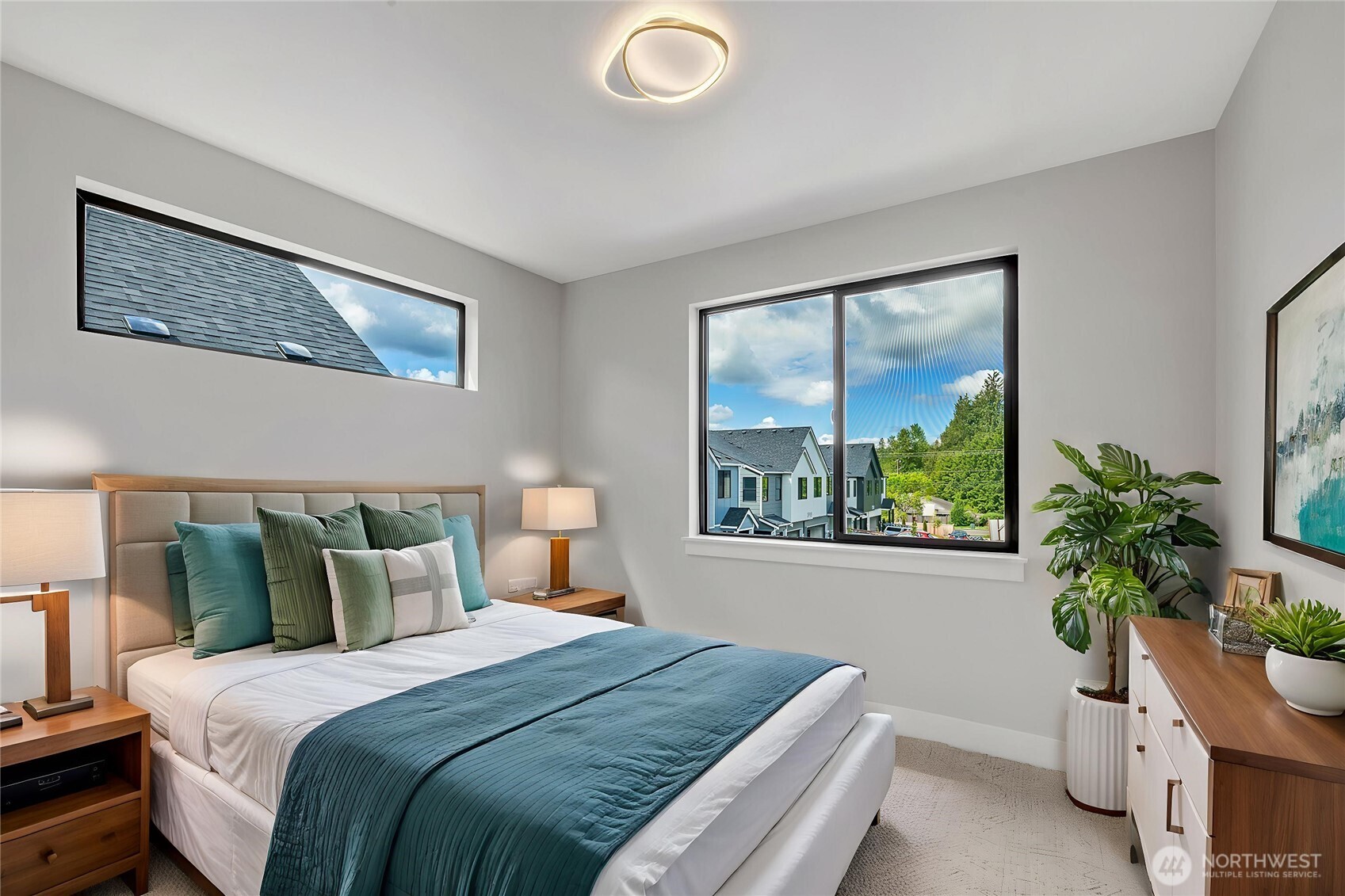 21408 39th Drive Southeast, Unit B Bothell, WA 98021 - Photo 16 of 34 a bedroom with a large bed and a potted plant