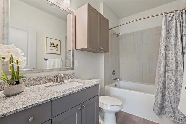 a view of house with a yard and potted plants