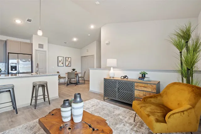 a view of a patio with table and chairs and garden