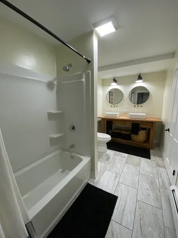 a bathroom with a bathtub and shower