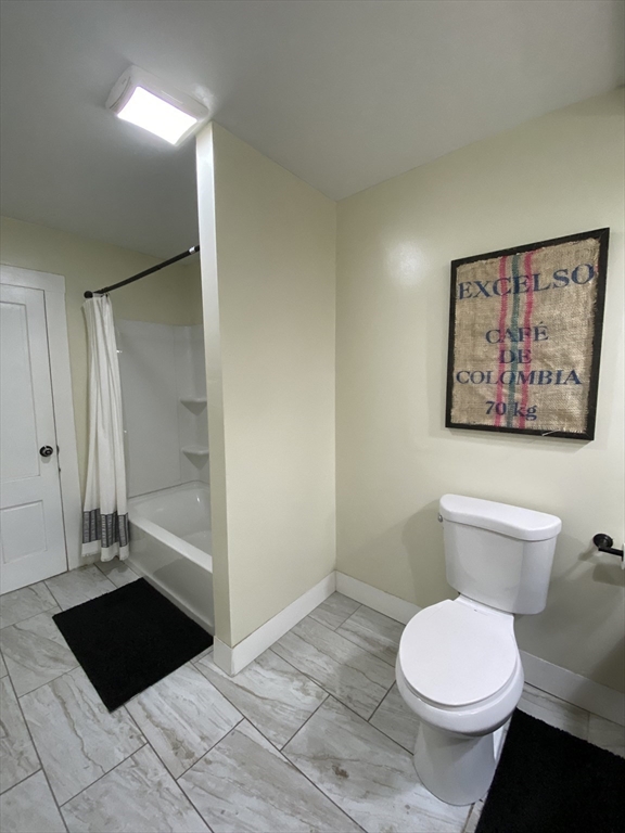 656 Grove Street, Unit 1 Worcester, MA 01605 - Photo 13 of 18 a bathroom with a toilet and a shower