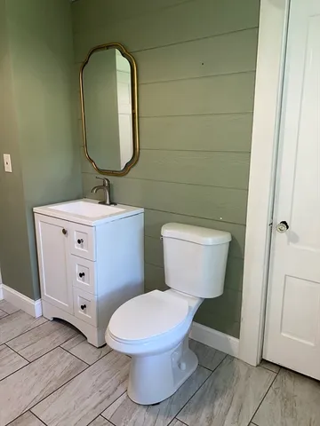 a white toilet sitting next to a bathroom sink