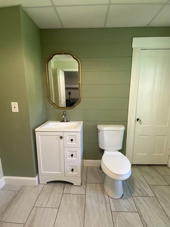 656 Grove Street, Unit 1 Worcester, MA 01605 - Photo 16 of 18 a bathroom with a toilet sink and mirror