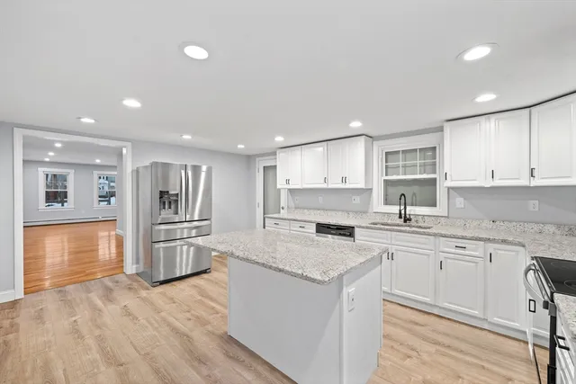 a kitchen with a sink stove and refrigerator