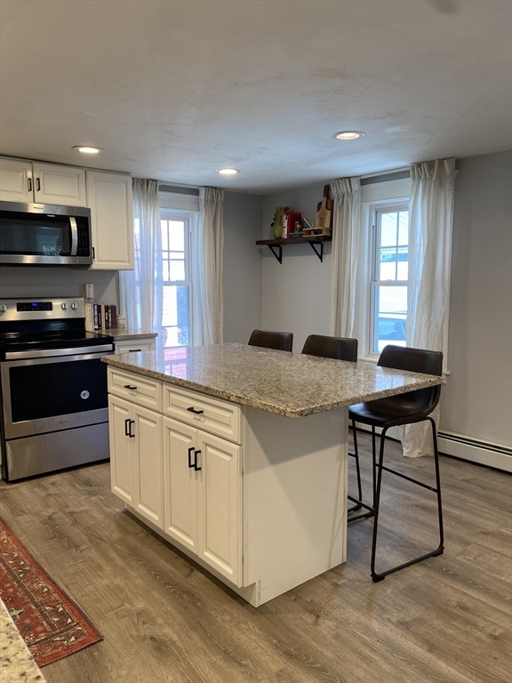 656 Grove Street, Unit 1 Worcester, MA 01605 - Photo 18 of 18 a kitchen with stainless steel appliances granite countertop a stove a sink and a microwave
