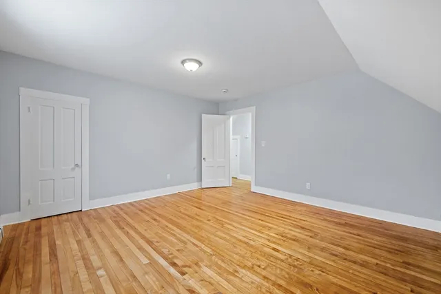 a view of an empty room and wooden floor