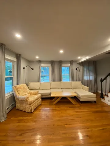 a living room with furniture and kitchen view