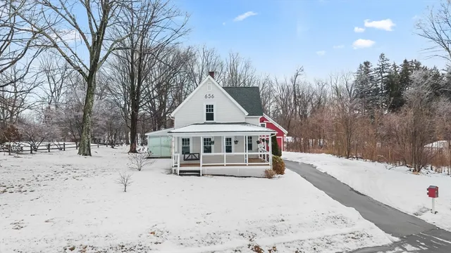 a view of a house with a yard covered in snow