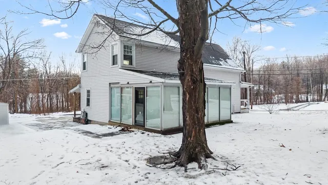 a wooden bench sitting in front of a house