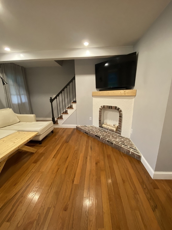 656 Grove Street, Unit 1 Worcester, MA 01605 - Photo 4 of 18 a bedroom with a bed and a flat screen tv