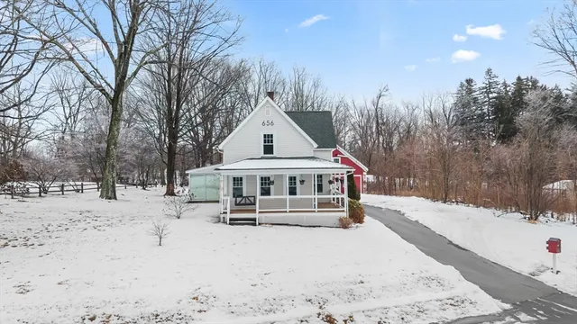 a view of a house with a yard covered in snow