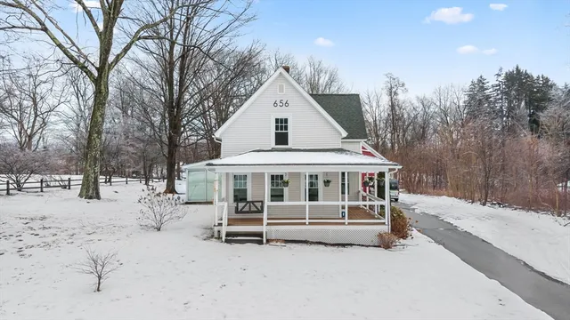 a view of house with a yard covered in snow