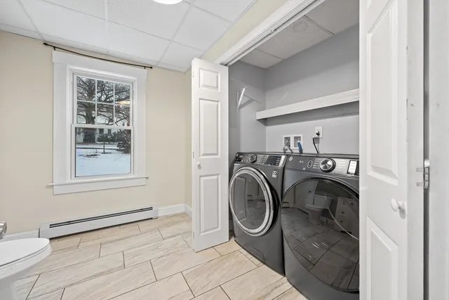 a view of a bedroom with washer and dryer