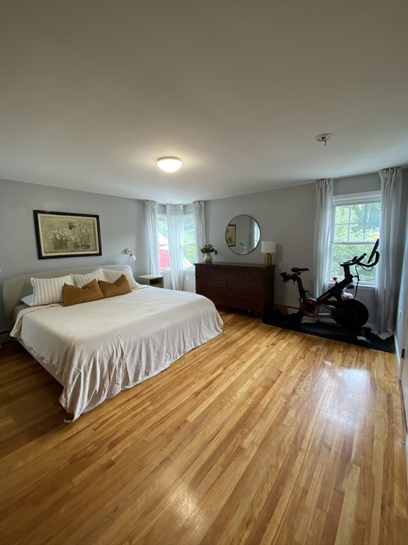 656 Grove Street, Unit 1 Worcester, MA 01605 - Photo 8 of 18 a spacious bedroom with a bed and wooden floor