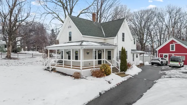 a view of a house with a yard covered in snow