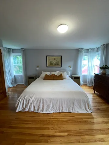 a bedroom with a bed and a view of kitchen