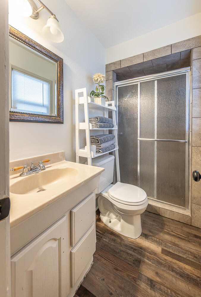 1710 43rd Street Lubbock, TX 79412 - Photo 12 of 20 a bathroom with a toilet a sink and shower