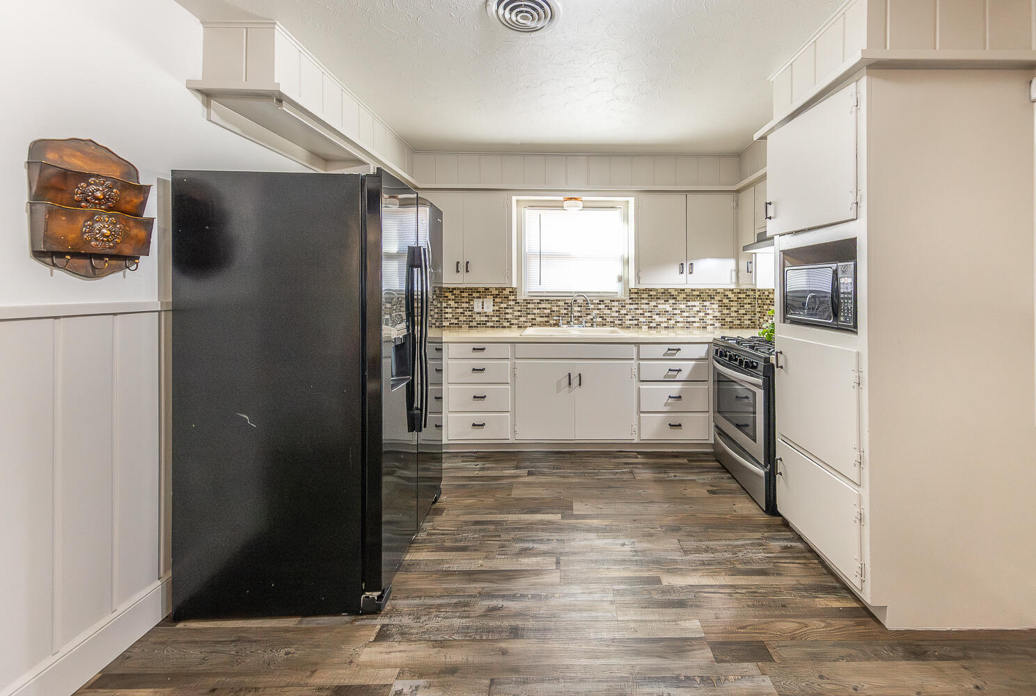 1710 43rd Street Lubbock, TX 79412 - Photo 3 of 20 a kitchen with stainless steel appliances a refrigerator and a stove