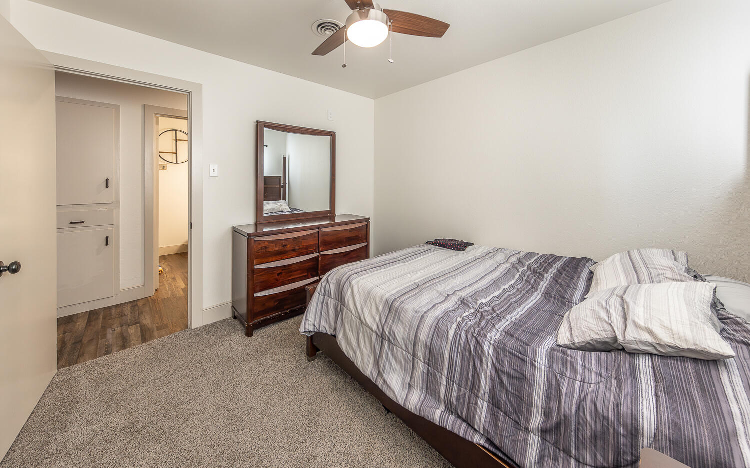 1710 43rd Street Lubbock, TX 79412 - Photo 9 of 20 a bedroom with a bed and a chandelier