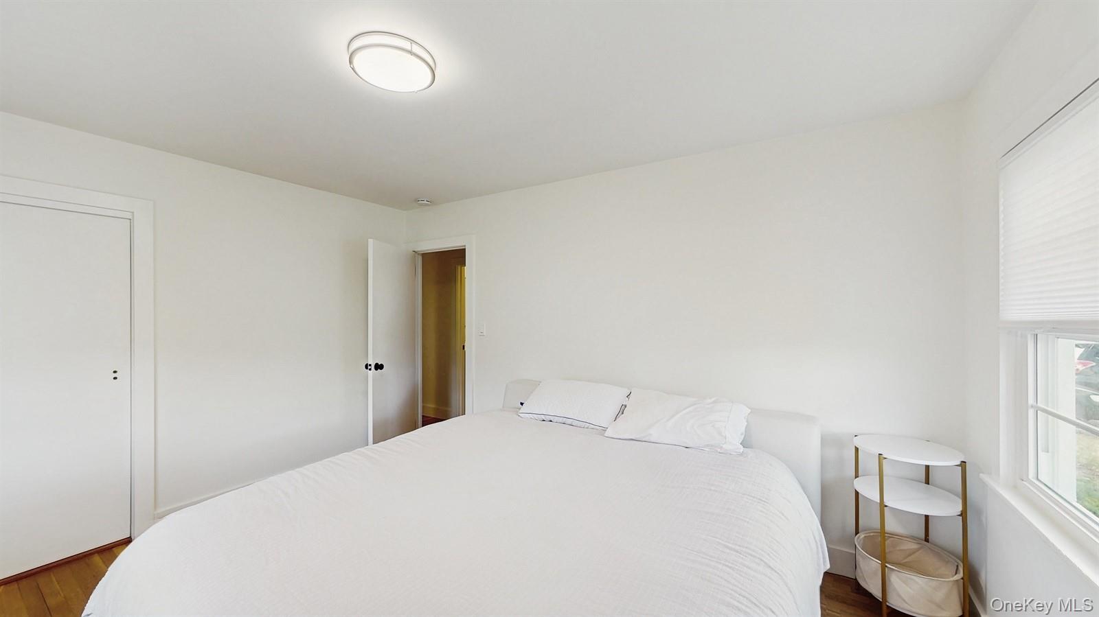 170 Wetherill Road Garden City, NY 11530 - Photo 13 of 23 Bedroom with dark wood finished floors