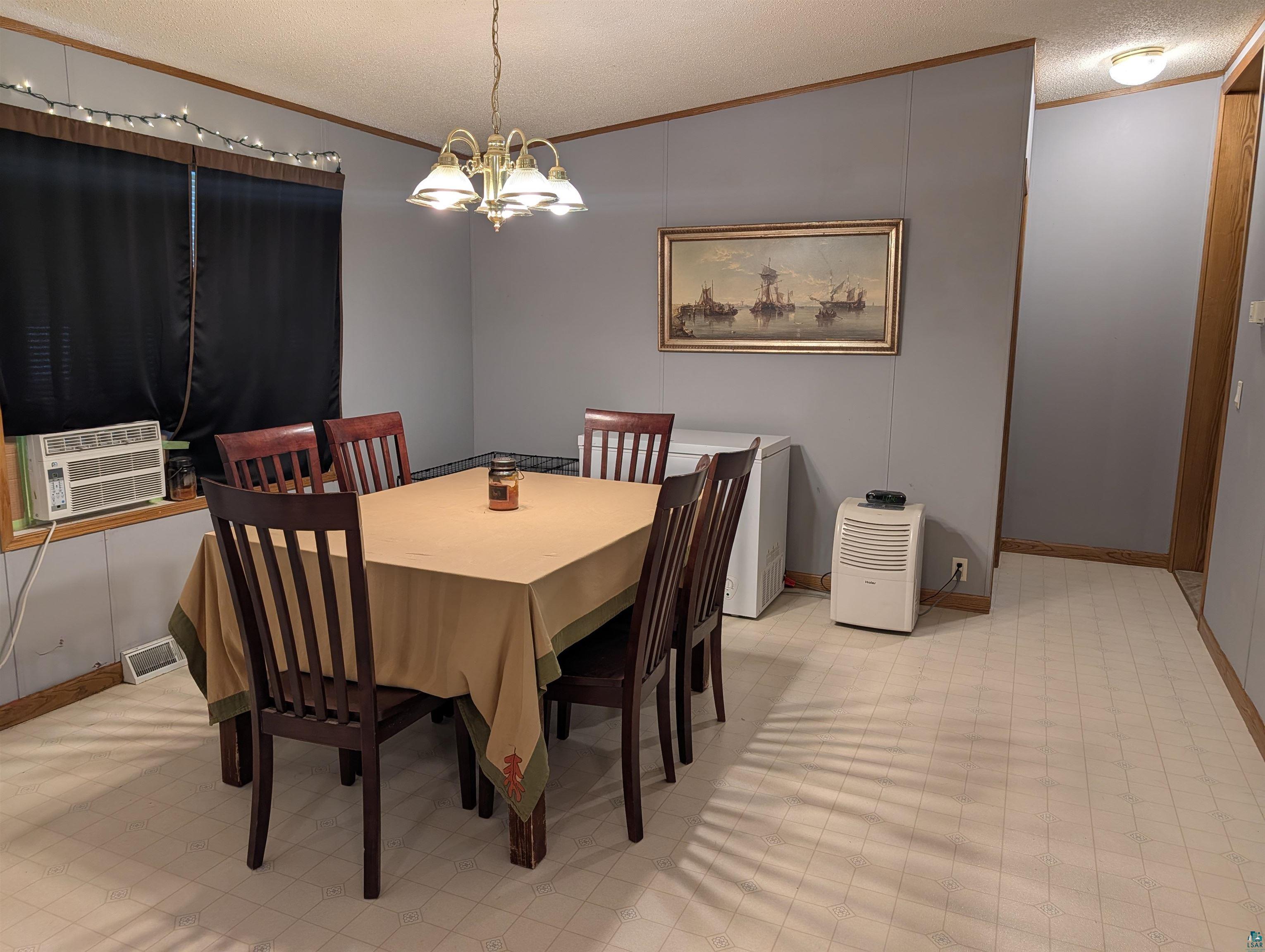 3945 Maple Street Kettle River, MN 55757 - Photo 2 of 41 Dining area with light-toned flooring, featuring a window and a ceiling-mounted light fixture