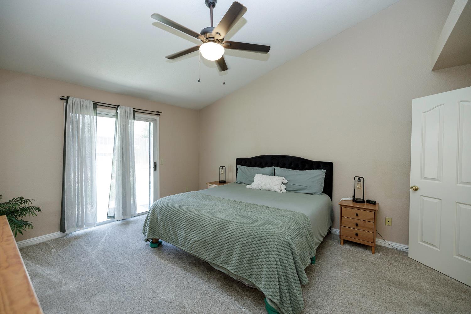 230 Meyenberg Avenue Ripon, CA 95366 - Photo 32 of 52 a bedroom with a bed and a chandelier
