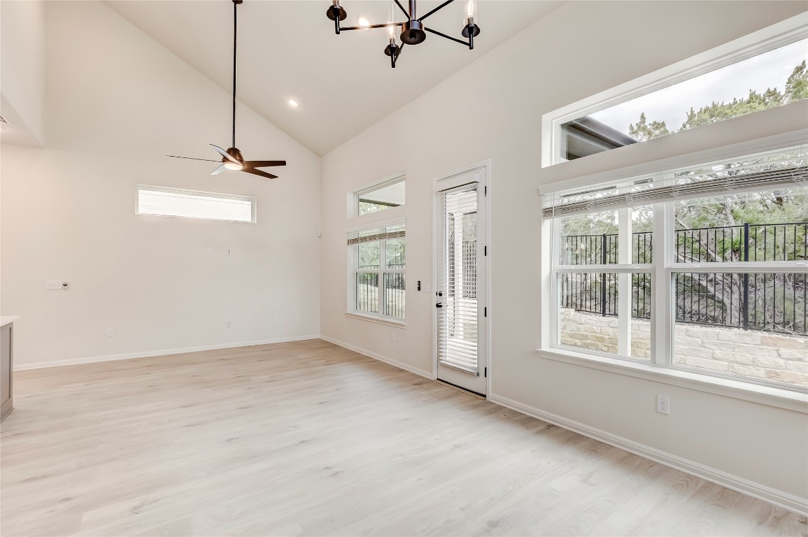 2008 Kit Circle Austin, TX 78758 - Photo 16 of 37 Foyer entrance with high vaulted ceiling, a chandelier, light wood-type flooring, ceiling fan, and recessed lighting