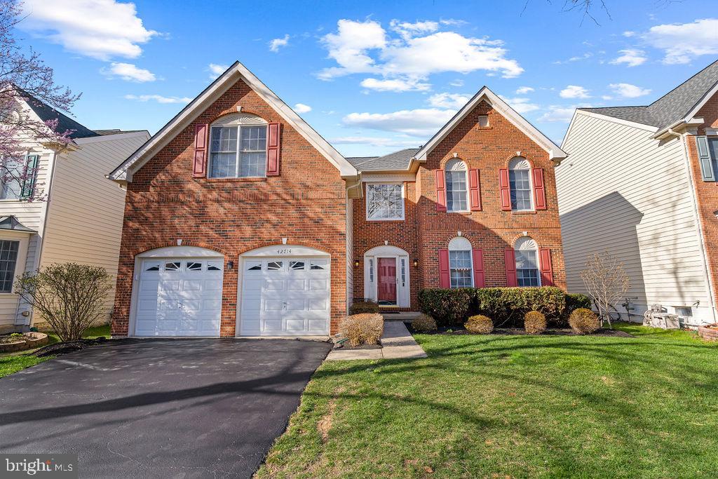 42714 Freedom Street Chantilly, VA 20152 - Photo 2 of 47 a front view of a house with a yard and garage