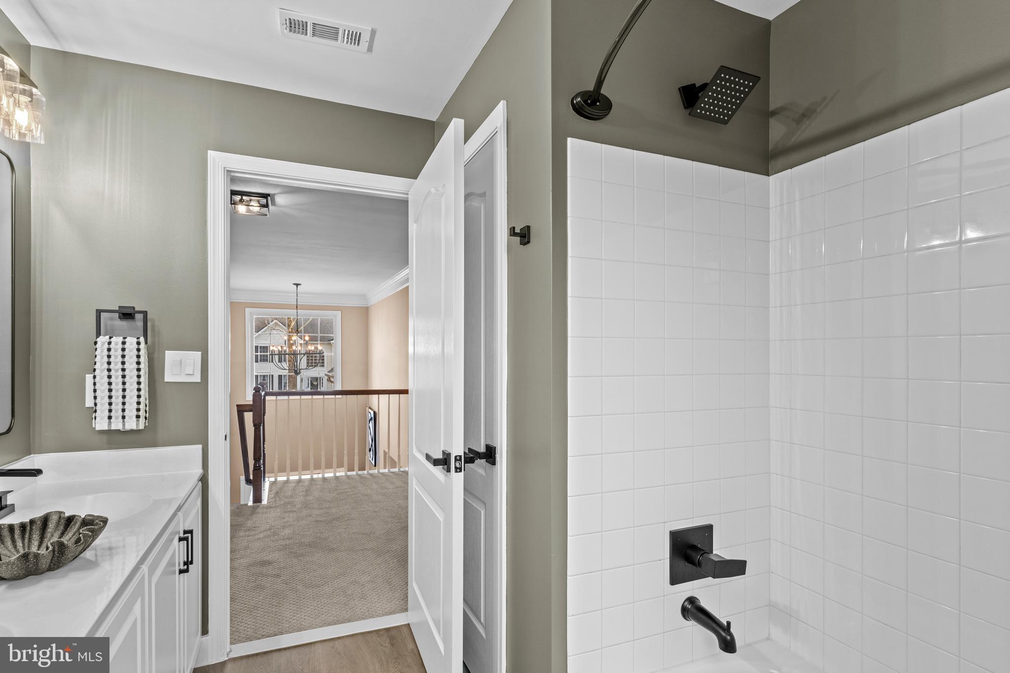 42714 Freedom Street Chantilly, VA 20152 - Photo 31 of 47 a view of a livingroom with a dinning area hardwood floor and a ceiling fan