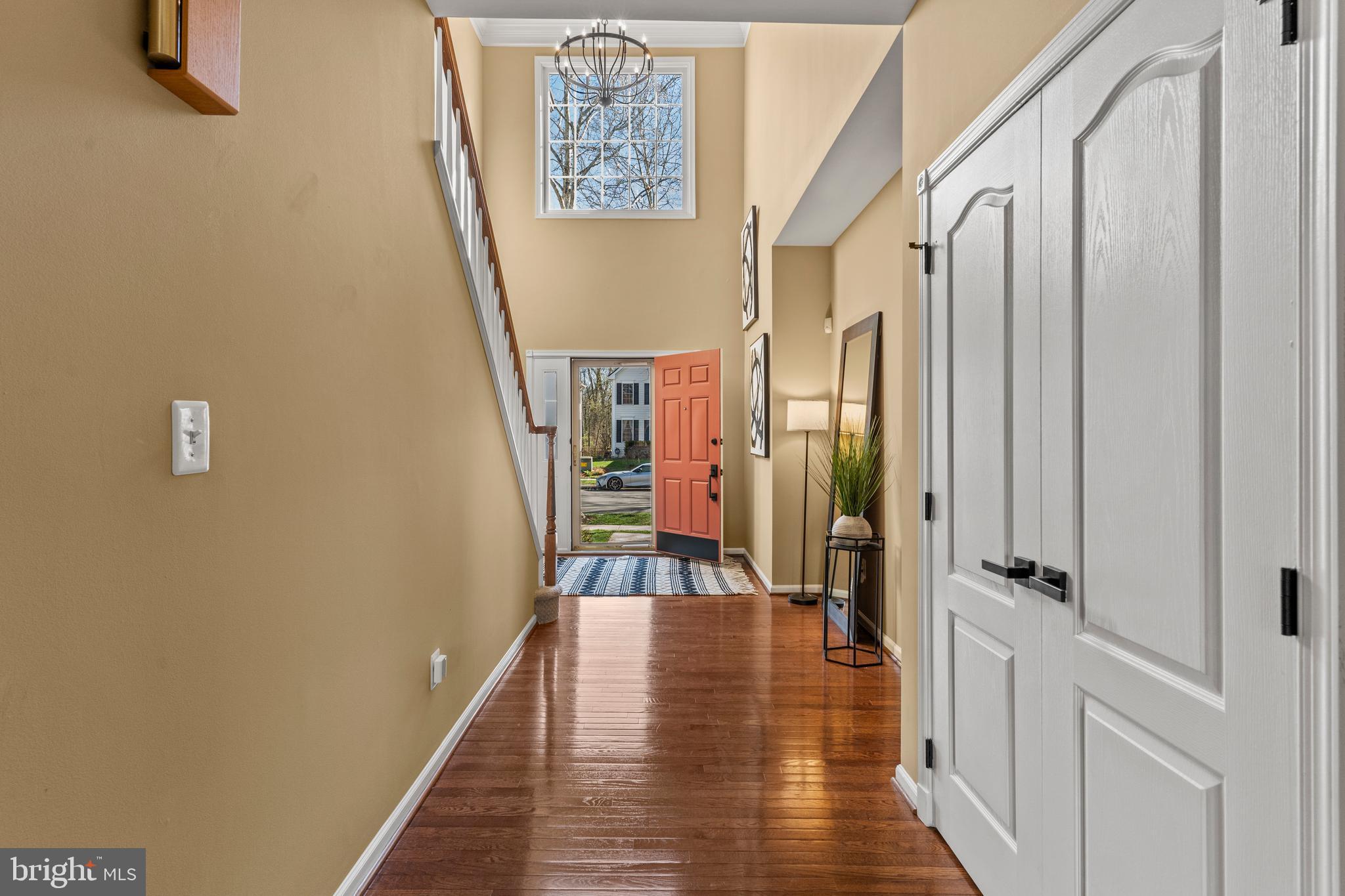 42714 Freedom Street Chantilly, VA 20152 - Photo 5 of 47 a view of a hallway with wooden floor and staircase